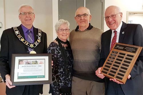 Lynn and Howard Hutcheson (centre) accepting the 2016 Frontenac County Access Award from Warden Ron Vandewal and Portland Councilor John McDougall., on behalf of the Bellrock Community Hall Association.
